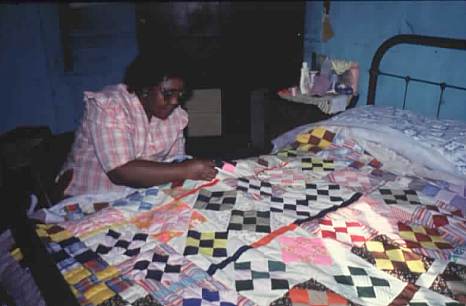 Rosie Allen of Homer quilts on a bed, a technique especially common in the African American community.