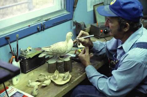 Willard Chauvin carves a bird from tupelo gumin his workshop.