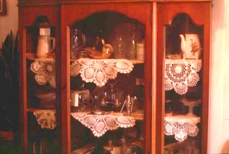 Minnie Lee Graves of Hico, Lincoln Parish displays her crochet doilies with her china.